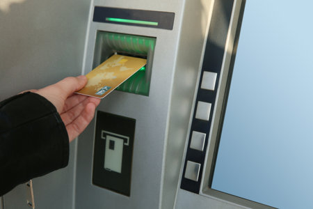 Woman with bank card using modern cash machine, closeup. ATMの写真素材