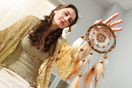 Woman with beautiful dream catcher at home, selective focusの写真素材