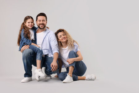 Happy family on gray background. Space for textの写真素材
