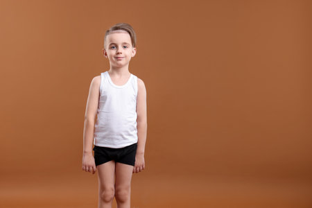 Little boy in underwear on brown background. Space for textの写真素材