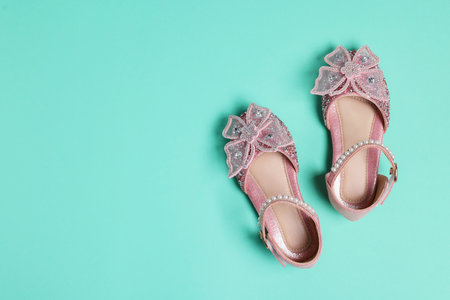 Pair of stylish kid's shoes on turquoise background, top view. Space for textの写真素材