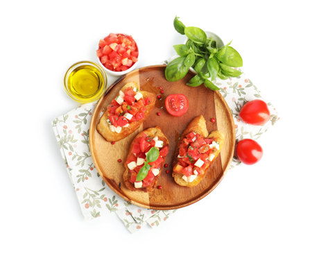Tasty bruschettas with tomatoes, mozzarella cheese and basil isolated on white, top viewの写真素材