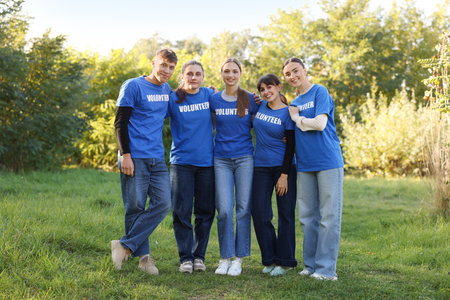 Group of happy volunteers together in parkの写真素材