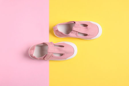 Pair of stylish kid's shoes on color background, flat layの写真素材