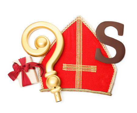 Saint Nicholas (Sinterklaas) day. Red mitre, chocolate letter S, golden crosier and gift box isolated on white, top viewの写真素材