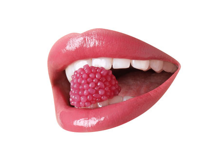 Lips with beautiful color holding raspberry candy in the mouth on white background, closeup