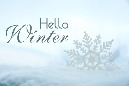 Hello winter card with snowflake in snowの写真素材