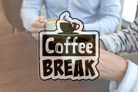 Colleagues having coffee break at wooden table in cafe, closeupの写真素材