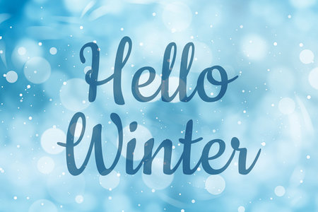 Hello winter card with snow on blue gradient background and bokeh lightsの写真素材