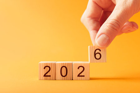 Woman putting cube with number 6 on orange background, closeup