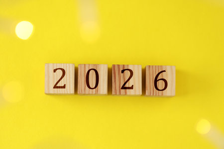 New 2026 year. Cubes with numbers on yellow background, top viewの写真素材