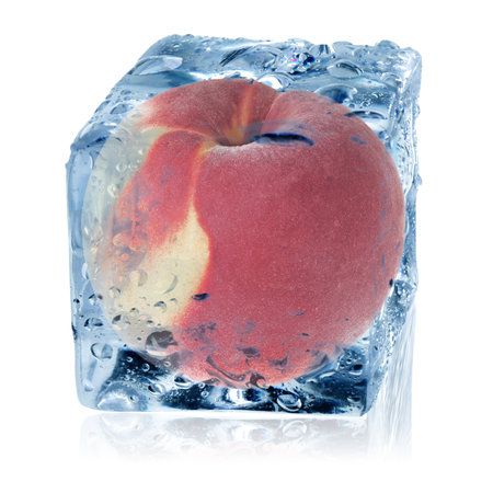 Fresh peach in ice cube isolated on whiteの写真素材