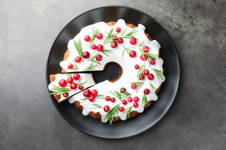 Tasty Christmas cake with cranberries on gray table, top viewの写真素材