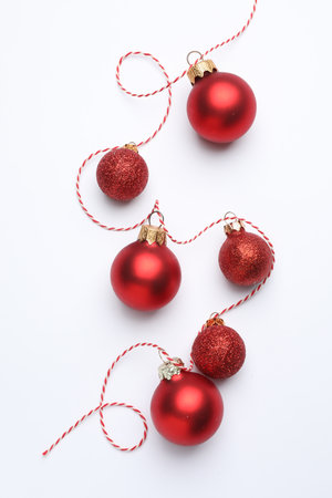 Red Christmas tree ornaments on white background, flat layの写真素材