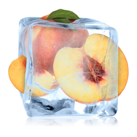 Fresh peaches in ice cube isolated on whiteの写真素材