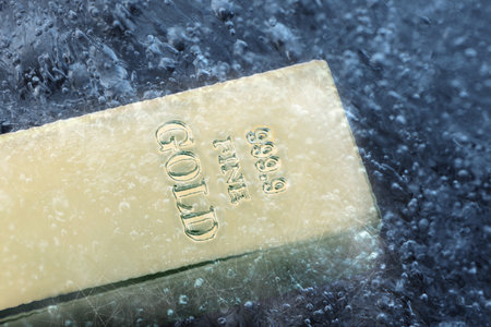 Gold bar in ice, closeup.の写真素材