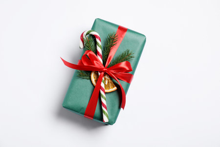 Decorated Christmas gift with candy cane on white background, top viewの写真素材