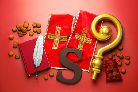 Saint Nicholas (Sinterklaas) day. Stole, crosier, book, feather, chocolate letter S, kruidnoten...