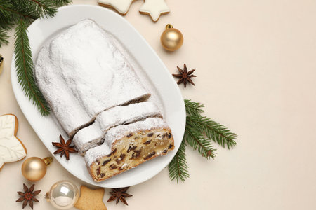 Cut traditional Stollen cake, cookies and Christmas decor on white table, flat lay. Space for textの写真素材