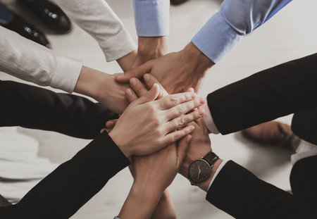 People holding hands together over light background, top view. Unity conceptの写真素材