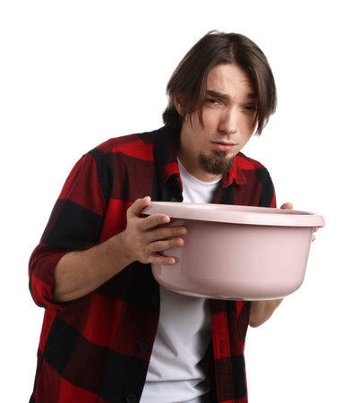 Man with basin suffering from nausea on white backgroundの写真素材