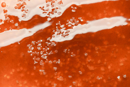 Delicious caramel sauce with salt as background, top viewの写真素材