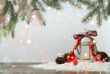 Merry Christmas and Happy Holidays card. Decorative lantern with candle inside and fir tree branches against light background, magic lightsの写真素材