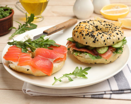 Delicious bagels with salmon served on wooden table, closeupの写真素材