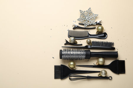 Christmas tree made of hairdresser's tools and decor on beige background, flat lay. Space for textの写真素材