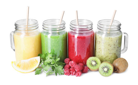 Different tasty smoothies in mason jars and ingredients isolated on whiteの写真素材