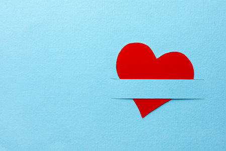 Red paper heart on light blue background, top view, Space for textの写真素材