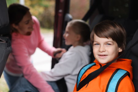 Mother taking her children to school by car, selective focusの写真素材