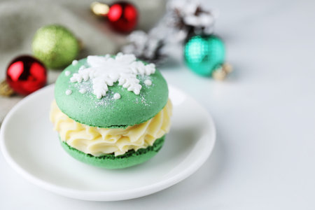 Tasty macaron and Christmas decor on white table, closeup. Space for textの写真素材