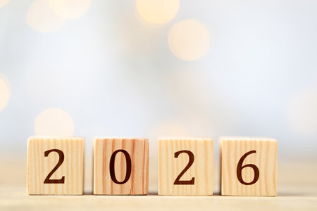 New 2026 year. Cubes with numbers on wooden table against light backgroundの写真素材