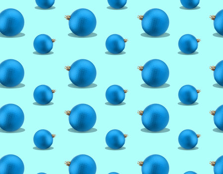 Christmas balls on light blue background. Festive repetitive patternの写真素材