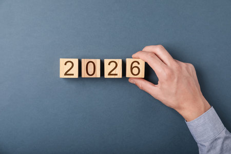 Man putting cube with number 6 on gray background, top viewの写真素材