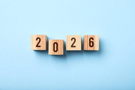 Cubes with numbers on light blue background, top view