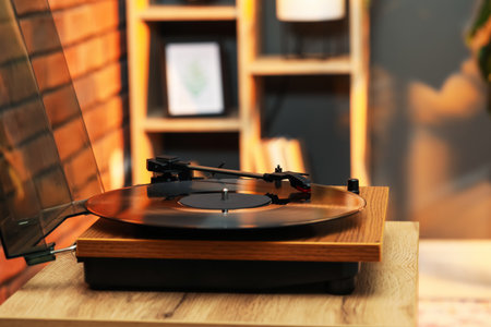 Modern turntable with vinyl record at home. Space for textの写真素材