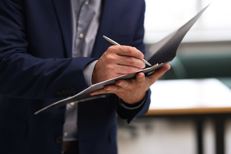 Real estate appraisal. Inspector with folder conducting property valuation at home, closeup
