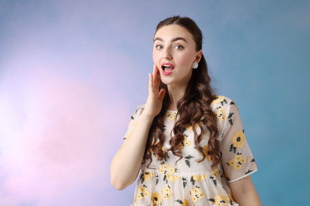 Beautifully dressed young woman on light blue background, space for textの写真素材