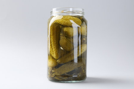Pickled cucumbers in jar on light background, closeupの写真素材