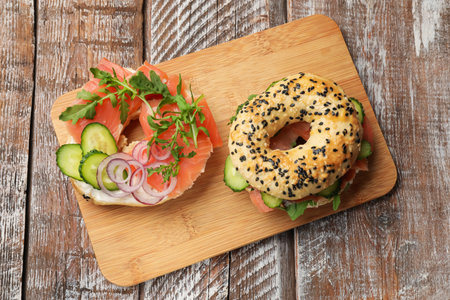 Bagels with salmon on wooden table, top viewの写真素材