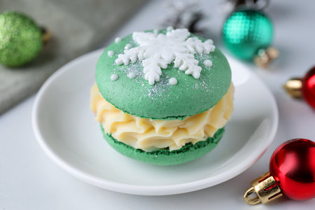 Tasty macaron and Christmas decor on white table, closeupの写真素材