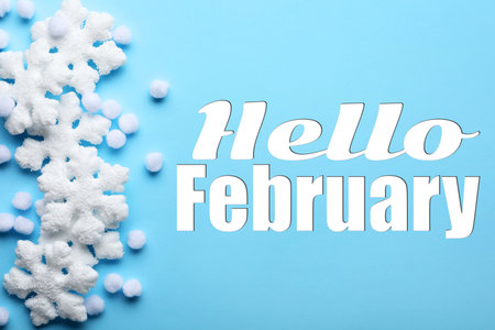 Hello February. Winter time card with decorative snowflakes on light blue backgroundの写真素材