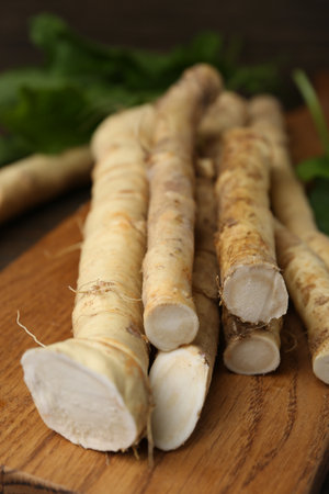 Fresh raw horseradish roots and leaves on wooden table, closeupの写真素材