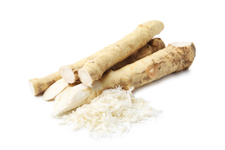 Grated horseradish and roots isolated on whiteの写真素材