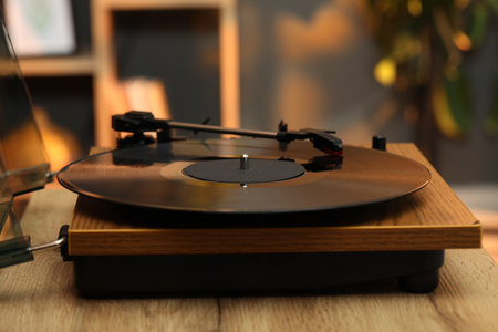 Modern turntable with vinyl record at home, closeup. Space for textの写真素材