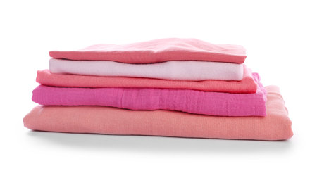 Stack of clean pink clothes isolated on whiteの写真素材