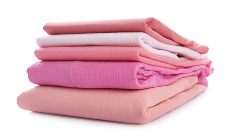 Stack of clean pink clothes isolated on whiteの写真素材