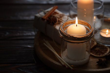 Christmas lanterns, matches and spices on wooden table, closeupの写真素材